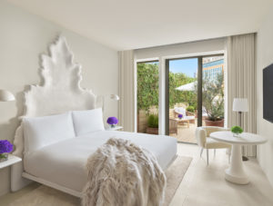 Stylish guest room with fur throw on bed