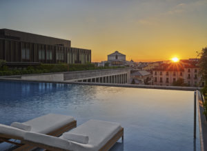 Rooftop infinity pool at sunset with city view