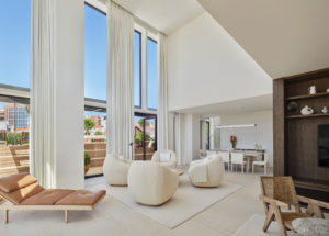 Modern, spacious living and dining area of penthouse