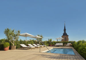 Private rooftop pool with sun loungers and umbrellas