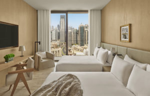 Guest room with two beds and city view