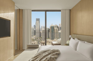 Guest room with city view and fur throw on bed