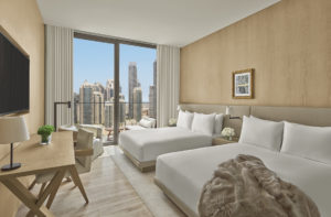 Guest room with two beds and city view