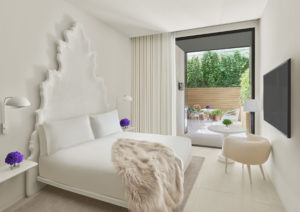 Bright, stylish guest room with fur throw on bed