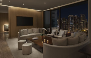 Living room of suite with nighttime city view